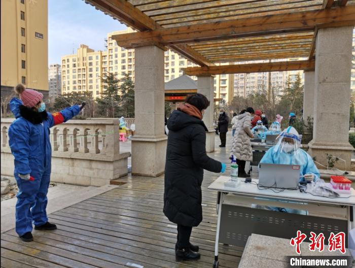圖為社區(qū)工作人員在維持秩序?！∏谌A 攝