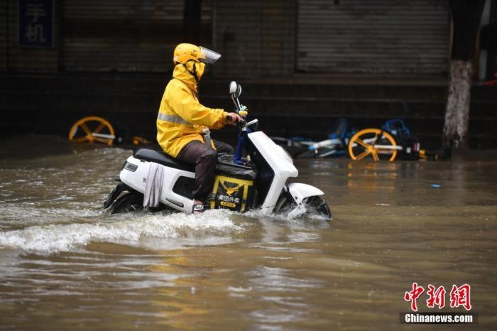 資料圖：外賣(mài)小哥通過(guò)積水路段。<a target='_blank' href='http://www.chinanews.com/'>中新社</a>記者 劉冉陽(yáng) 攝