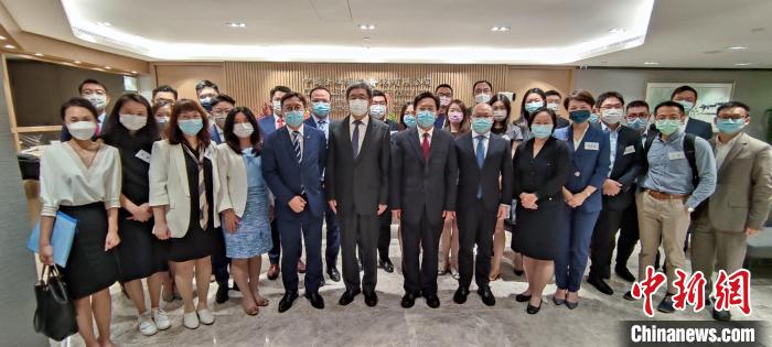 香港中聯(lián)辦秘書長王松苗一行與“港漂”律師們合影?！∠愀壑新?lián)辦供圖