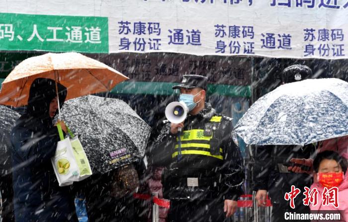 7日上午，南京公安干警冒雪值守在人流量較大的地區(qū)，保障行人安全?！?攝