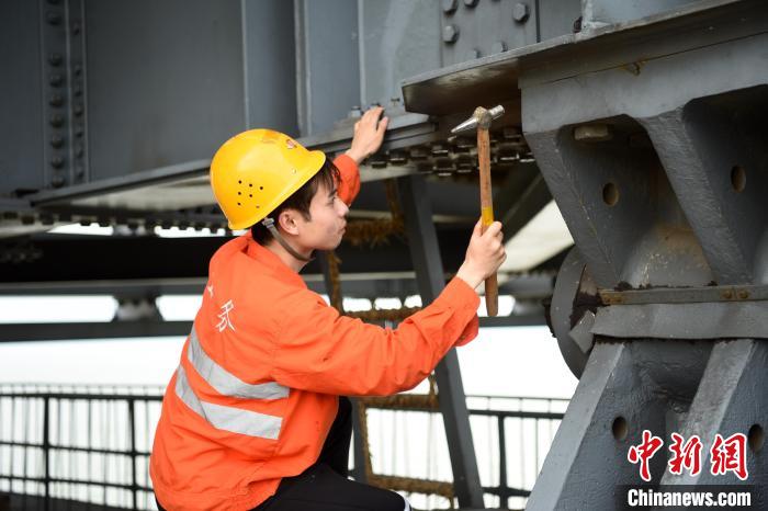 6月24日，南鐵九江橋工段的橋梁工正在九景衢鐵路鄱陽(yáng)湖大橋上對(duì)高強(qiáng)度螺栓進(jìn)行檢查更換。　 黃旸 攝
