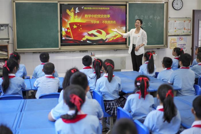 2022年5月5日，在重慶市九龍坡區(qū)鐵路小學(xué)四年級二班的課堂上，數(shù)學(xué)老師?？≤餐ㄟ^講述數(shù)學(xué)家華羅庚的故事開展黨史教育活動。新華社記者 劉潺 攝