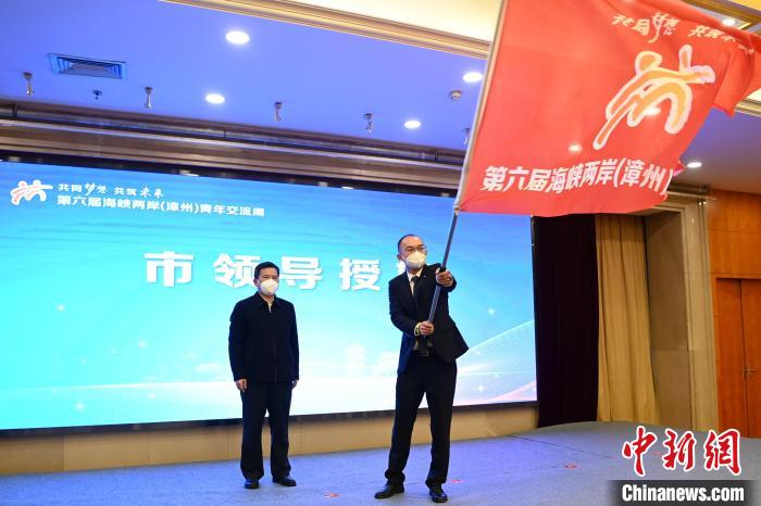 漳州市委副書記黃水木(左)為臺(tái)青代表曾冠穎授旗?！埥鸫?攝