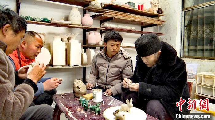 圖為張福高一家在捏制兔子?！『蚊髦?攝