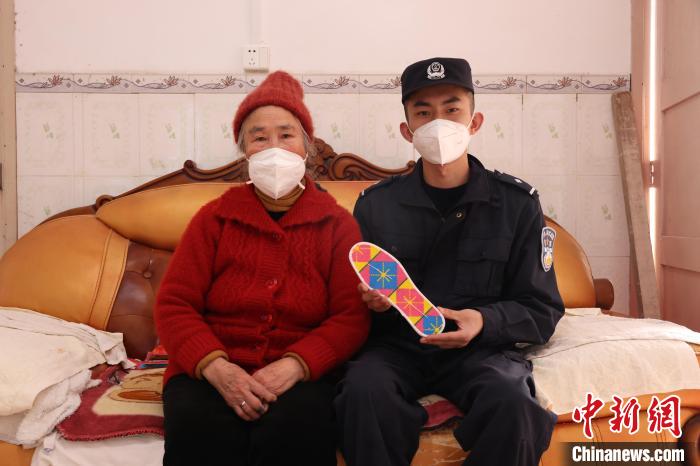 圖為羅金娥(左)與民警合影?！∥纳竭吘彻芾碇ш?duì)供圖