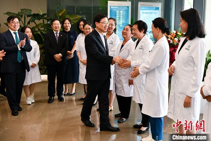 3月29日，前來海南參加博鰲亞洲論壇2023年年會(huì)的香港特別行政區(qū)行政長官李家超一行參觀考察了博鰲樂城國際醫(yī)療旅游先行區(qū)。該園區(qū)是海南自貿(mào)港重點(diǎn)園區(qū)，目前有四家港資企業(yè)投資。圖為李家超參訪港資醫(yī)療機(jī)構(gòu)海南德雅醫(yī)院并與醫(yī)護(hù)人員握手。 <a target='_blank' href='/'>中新社</a>記者 駱云飛 攝 　