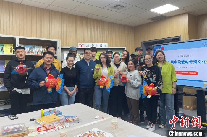 留學(xué)生們手持親手制作的中國(guó)傳統(tǒng)玩具合影留念?！⌒吕俪霭嫔绻﹫D