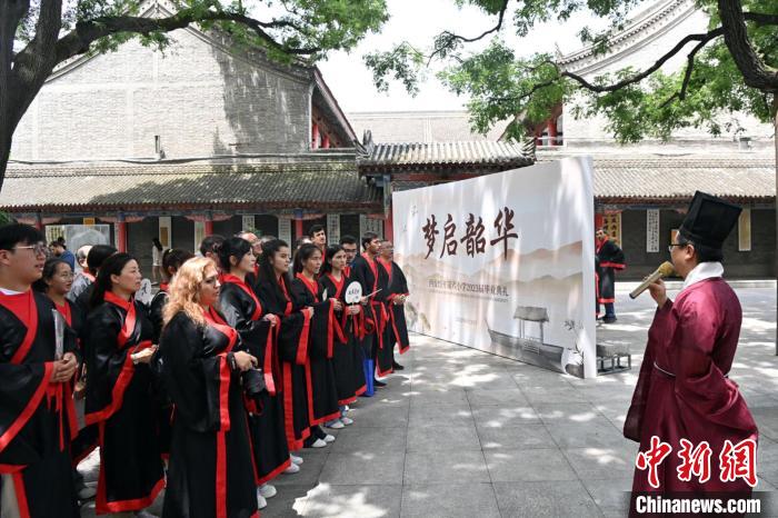 圖為主禮官給參與研學(xué)的學(xué)生介紹漢服及相關(guān)禮儀制度?！【琶赖┰?攝