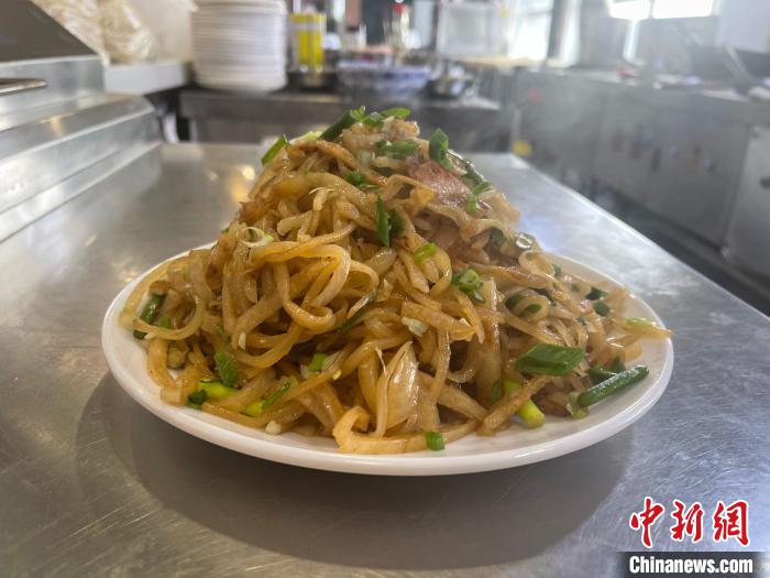 做好的長子炒餅，吃時加香醋，配大蒜瓣，滿口生香。　楊靜 攝
