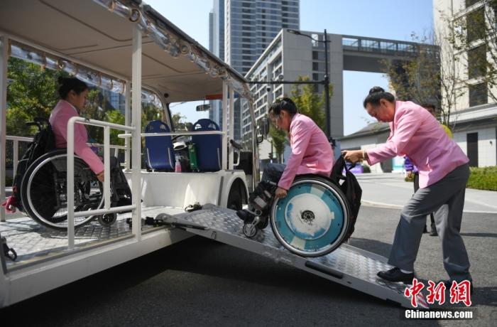 資料圖：10月16日，運(yùn)動員在亞殘運(yùn)村使用無障礙接駁車。<a target='_blank' href='/'>中新社</a>記者 王剛 攝