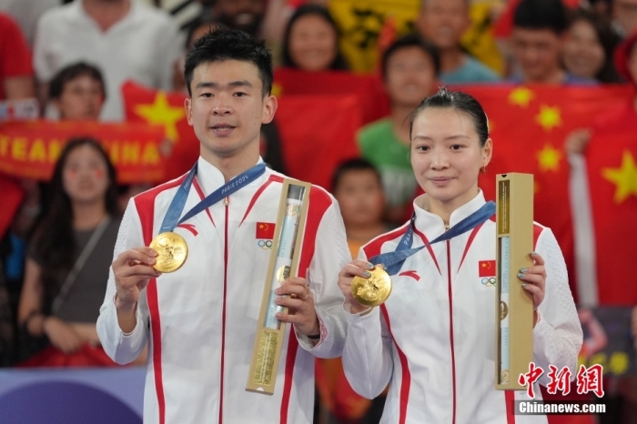 當?shù)貢r間8月2日，在巴黎奧運會羽毛球混合雙打決賽中，中國組合鄭思維/黃雅瓊以2-0勝韓國組合金元昊/鄭娜銀，獲得金牌。圖為頒獎儀式上，鄭思維/黃雅瓊（右）展示金牌。<a target='_blank' href='/'>中新社</a>記者 趙文宇 攝